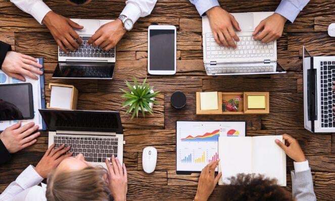 Workmates working together in one desk.