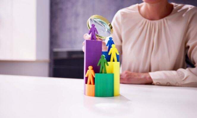 Woman using a magnifying glass representing an audience segmentation.