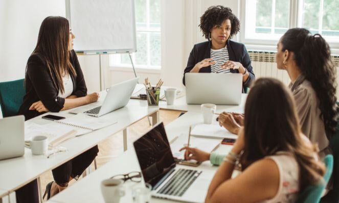 Women having a meeting in a conference room.