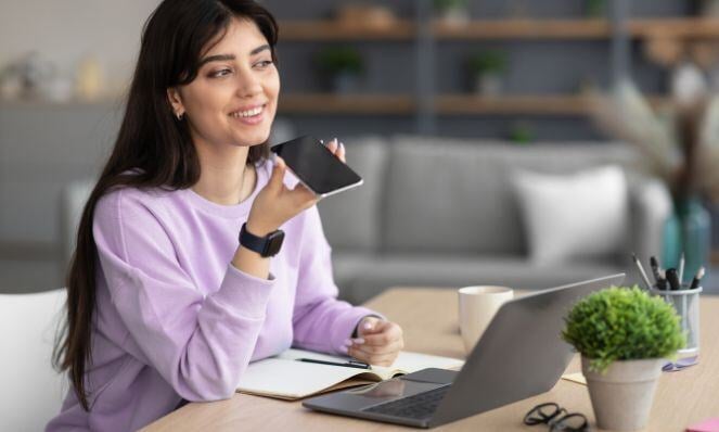 Woman using voice search through her mobile phone.