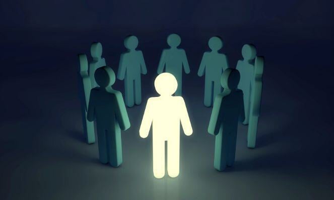 Graphic representation of a leader glowing in the dark while surrounded by others in a circle who are not illuminated.