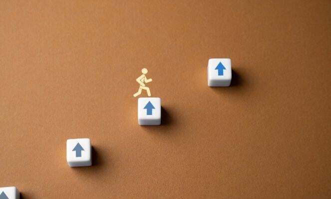 A graphic representation of a person moving up.