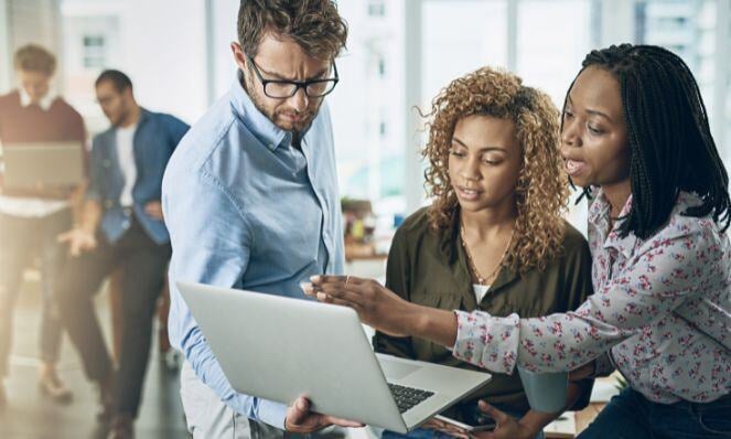 People working together on one laptop.