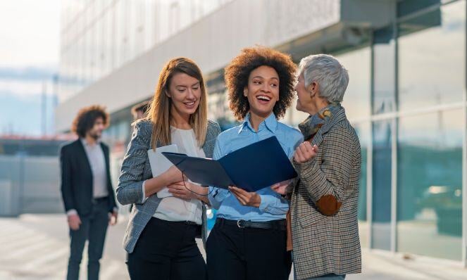 Workmates working together while all smiles.