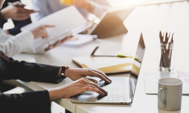 people working together on their laptops.