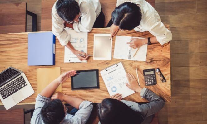 Workmates collaborating on an audit.