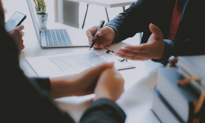 Agency owner explaining something to their client.