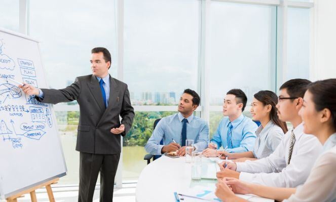 Person presenting and training his workmates.