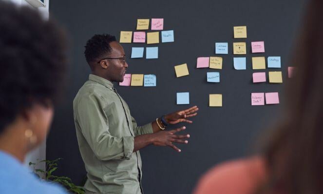 Person discussing infront of people.