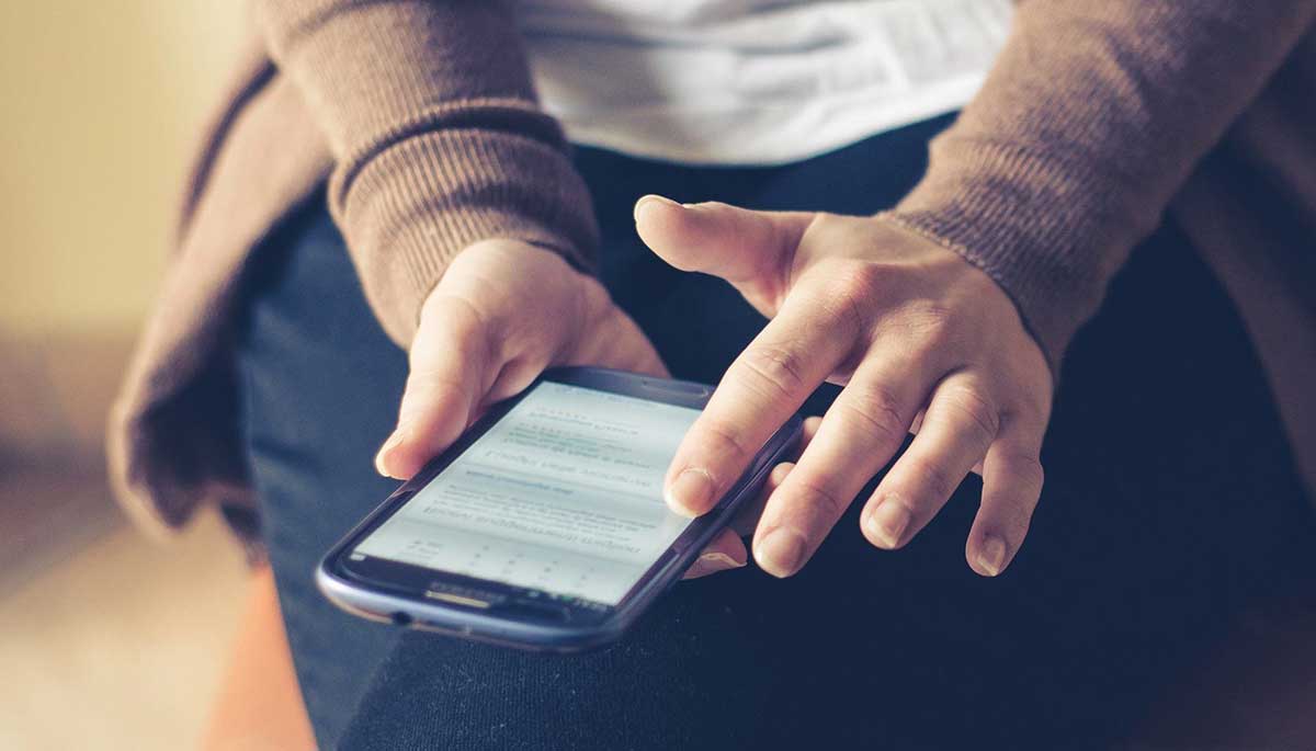 a person holding his mobile phone.