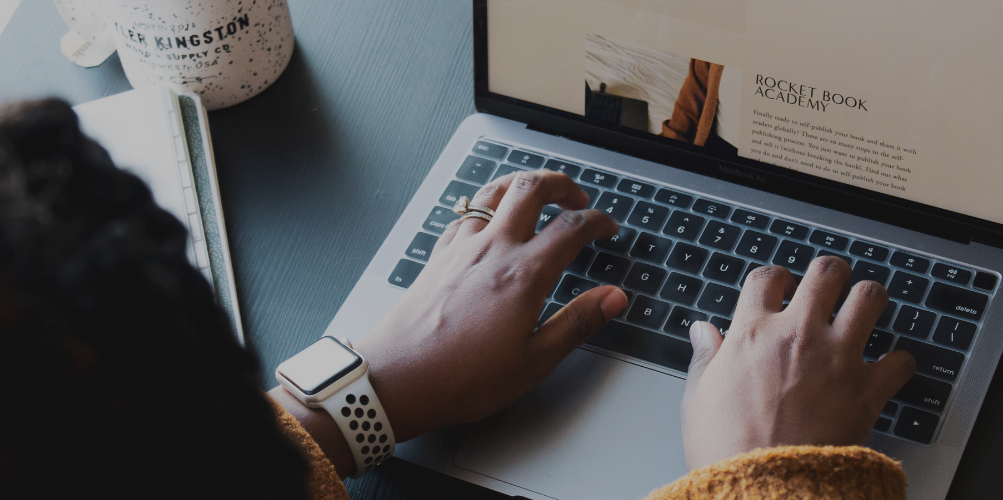 woman writing blog post on laptop